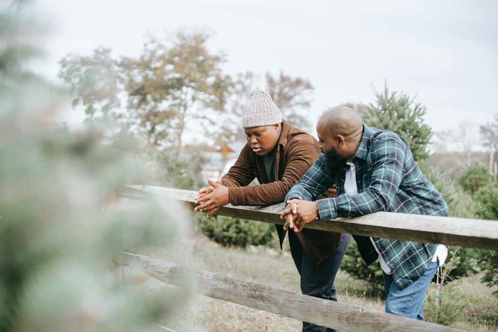 Intergenerational Contemplative Discussion: Older and Younger Males Sharing Wisdom by the Fence